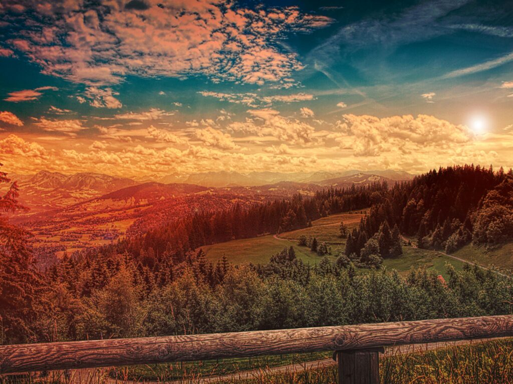 Beautiful mountain landscape with a forest at sunset, vibrant sky and scenic views.
